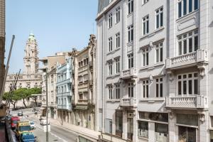 a street in the city with buildings and cars at Rivoli Apartments in Porto