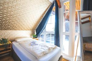 a bed in a room with a large window at Golden Nugget - Wohnungen und Apartments der besondern Art! in Bünde