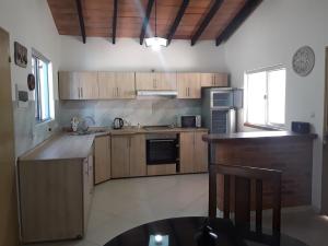 a kitchen with wooden cabinets and a counter top at Casita-Azul in Ypacarai