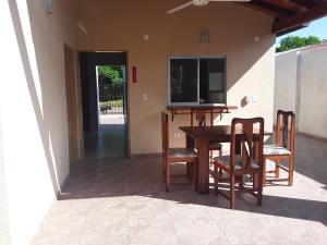 a porch with a table and chairs and a television at Casita-Azul in Ypacarai