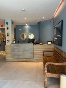 a lobby with a bench and a counter with mirrors at Fortpraia Hotel in Fortaleza