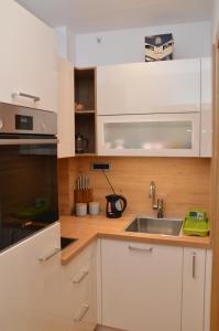 a kitchen with white cabinets and a sink at Unca in Belgrade