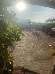 a stone patio with the sun in the background at Casa Gutiérrez in Teotitlán del Valle
