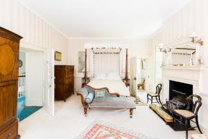 a bedroom with a bed and a fireplace at Upper Court in Kemerton