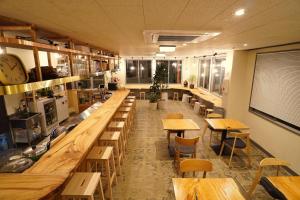 a restaurant with wooden tables and chairs in a room at La Union Double room with share bath room - Vacation STAY 31425v in Fukushima +2 photos