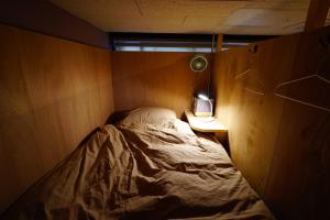 a small bedroom with a bed and a lamp at La Union - Vacation STAY 99795v in Fukushima