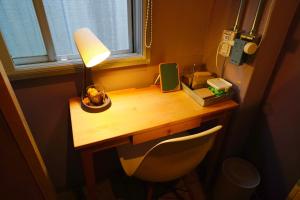 a wooden desk with a lamp and a chair at La Union - Vacation STAY 99795v in Fukushima +3 photos