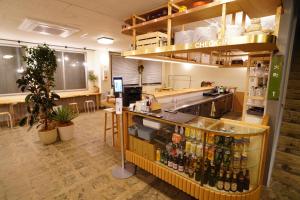 a restaurant with a counter with bottles of alcohol at La Union - Vacation STAY 99795v in Fukushima