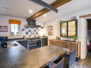 a kitchen with a table and a stove top oven at The Carriage House in Lyme Regis