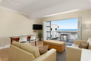 a living room with a view of the ocean at Caprice Court 6 in Cape Town