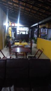 a dining room with a table and chairs in a room at POUSADA YHWH (Pedro & Neth) in Araruama