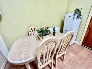 a dining room table and chairs with a plant on it at Cosy 2 Bed House in Rochdale in Rochdale