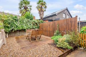 a patio with two chairs and a fence at Stylish 2 bed city centre house in Norwich
