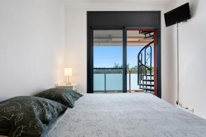 1 dormitorio con 1 cama y vistas al océano en Appartement de vacances avec vue mer , terrasses , solarium et Wi-Fi, en L'Eucaliptus