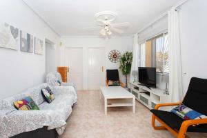 ein Wohnzimmer mit Sofa und Fernseher in der Unterkunft CH Marquesa Golf (Ciudad Quesada) in Rojales