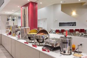 a buffet line in a restaurant with food on it at Universal and Convention Center Best Resort Studio in Orlando
