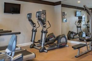 a gym with several cardio machines in a room at Universal and Convention Center Best Resort Studio in Orlando