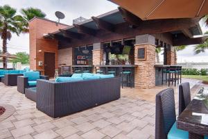 an outdoor patio with blue furniture and a bar at Universal and Convention Center Best Resort Studio in Orlando