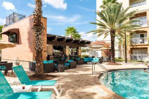 a resort with a swimming pool and palm trees at Universal and Convention Center Best Resort Studio in Orlando