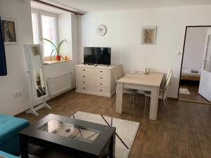a living room with a table and a dining room at U lesního muže in Střelice