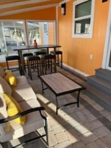 a living room with a couch and a table at Flamingo Tiny Home in Sarasota