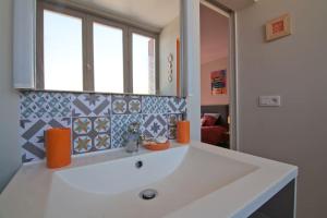 un bagno con un lavandino bianco e uno specchio di Le petit Marcel - Saint-Julien-les-Villas a Saint-Julien-les-Villas