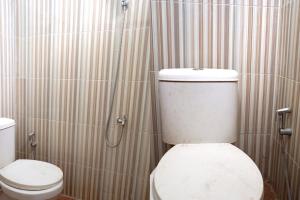 uma casa de banho com um WC e um chuveiro em OYO 92938 Kost Putih Syariah em Blitar