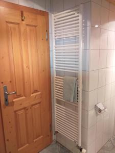 a bathroom with a shower with a towel and a door at Wagner-Schneider-Hof in Chieming