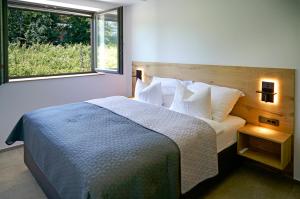 a bedroom with a bed and a large window at Posestvo Gjerkeš in Rogašovci