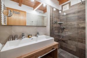 a bathroom with a sink and a shower at nawu apartments in Hermagor
