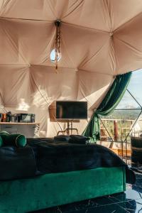 a bedroom with a bed in a tent at Góralski Harem Osada Glamp Jacuzzi & Balia in Zakopane