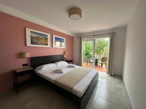 a bedroom with a large bed and a large window at Villa 8 Islas in Costa Del Silencio +66 photos