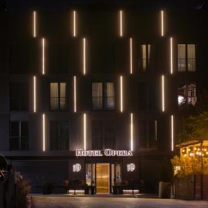 a hotel at night with lights on the facade at Hotel Opera in Pristina