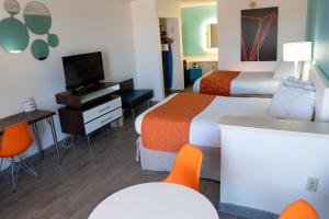 een hotelkamer met 2 bedden en een flatscreen-tv bij Howard Johnson by Wyndham Clearwater - Dunedin in Clearwater