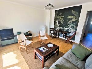 a living room with a couch and a table at Petit Radet 350m de la plage in Les Sables-dʼOlonne