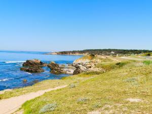 a view of a beach with rocks in the water at Petit Radet 350m de la plage in Les Sables-dʼOlonne