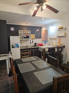 a kitchen with a table and a ceiling fan at Luz Del Alma in Las Gaviotas