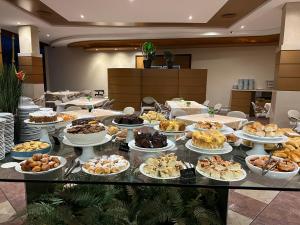 a buffet of food on a table in a room at Continental Inn in Foz do Iguaçu