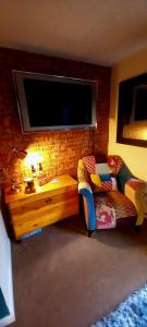 a living room with a couch and a table and a tv at Wolds View Hideaway in Scarborough