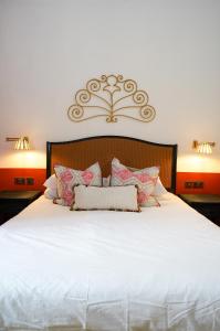 a bedroom with a large white bed with two lamps at Malta Luxe Guest Suite Central Location in Mosta