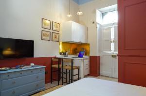 a kitchen with a desk and a laptop on a counter at Central Malta Luxe Suite Prime Location in Mosta