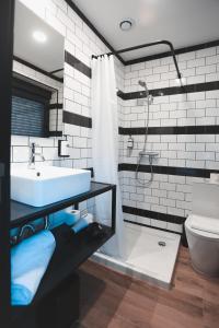 a bathroom with a sink and a shower and a toilet at Alma Candida 22 in Valença