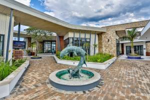 a statue in a fountain in front of a building at 169 Ballito Hills in Ballito
