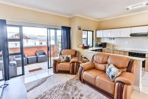 a living room with two chairs and a couch at 169 Ballito Hills in Ballito
