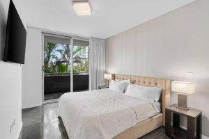 a bedroom with a bed and a large window at BOULAN HOTEL MIAMI BEACH BY IMD MIAMI 1BR/1BA UNIT in Miami Beach