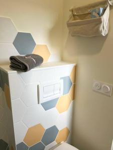 a bathroom with a toilet and a towel at St Bruno - Studio « Palmiers » in Grenoble +19 photos