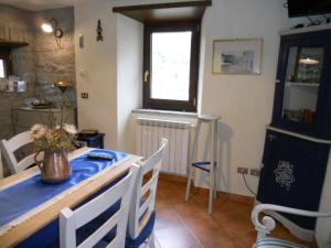 a dining room with a blue table and chairs at Torre Riva Dimora storica in Fiumalbo