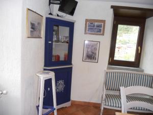 a room with a blue cabinet and a stool at Torre Riva Dimora storica in Fiumalbo