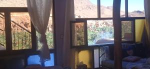 a room with windows with a view of a mountain at Guesthouse Panorama Todra in Tinerhir