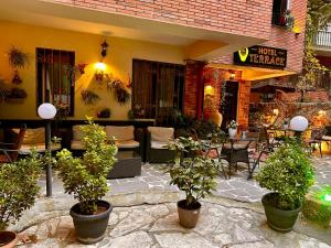 a patio with potted plants in front of a restaurant at Terrace Tbilisi Center in Tbilisi City